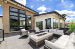 This stunning property boasts a spacious outdoor patio perfect for entertaining, complete with a modern fire pit and comfortable seating.