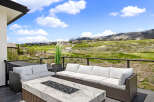 Luxury patio overlooking a stunning golf course and mountain vista.