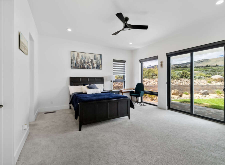 This bedroom boasts a modern design with large windows offering stunning views.