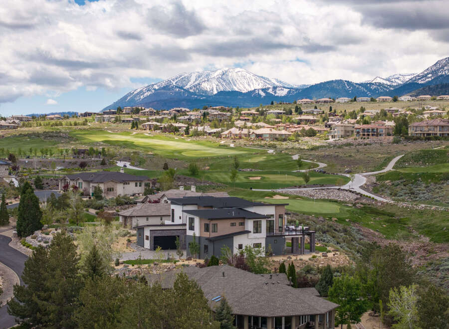 Luxury homes nestled on a golf course with breathtaking mountain views.