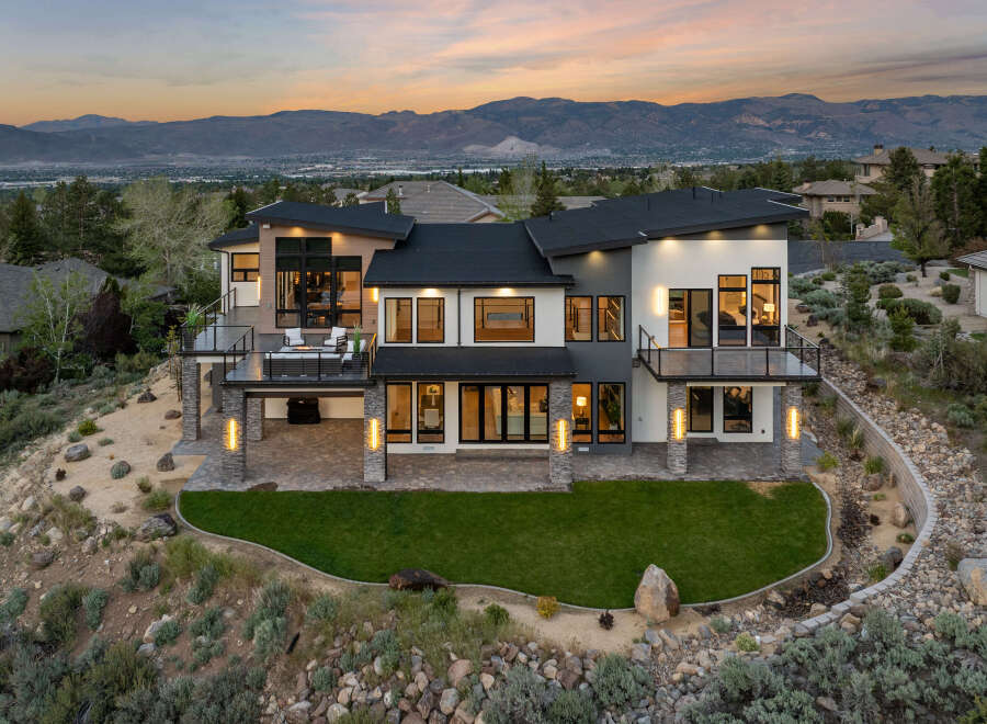 Stunning modern home nestled in the mountains with breathtaking sunset views.