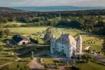 This stunning property boasts a majestic castle as its centerpiece, surrounded by meticulously landscaped gardens and expansive green fields.