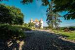 Discover this stunning castle property, boasting a charming cobblestone driveway leading to its majestic entrance.