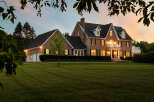 This stunning brick home boasts a spacious layout, complete with a three-car garage and beautifully landscaped grounds.