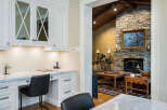 This stunning home boasts a bright and airy kitchen with custom cabinetry and a built-in workspace, perfect for busy professionals.