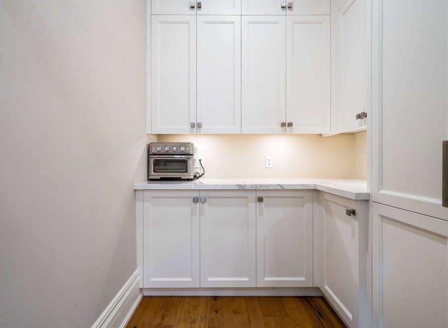 This stunning kitchen boasts a built-in oven and ample cabinetry, perfect for any culinary enthusiast.