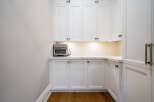 This stunning kitchen boasts a built-in oven and ample cabinetry, perfect for any culinary enthusiast.