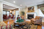 This stunning living room boasts hardwood floors, a cozy fireplace, and elegant furnishings.