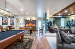 This stunning basement boasts a game room with a pool table, foosball table, and a home theater.