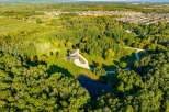 Nestled in a serene forest setting, this expansive property boasts a charming house with a spacious driveway.