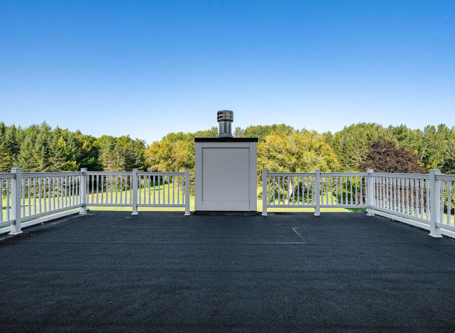 This stunning property boasts a private rooftop deck, perfect for enjoying breathtaking views of the surrounding landscape.