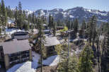 Luxury mountain condos nestled in a snowy landscape, offering breathtaking views of the majestic mountains.