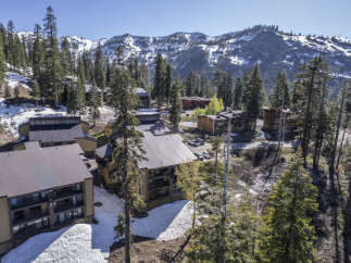 Luxury mountain condos nestled in a snowy landscape, offering breathtaking views of the majestic mountains.