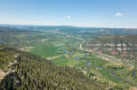 This stunning property boasts breathtaking panoramic views of the valley, river, and surrounding mountains.