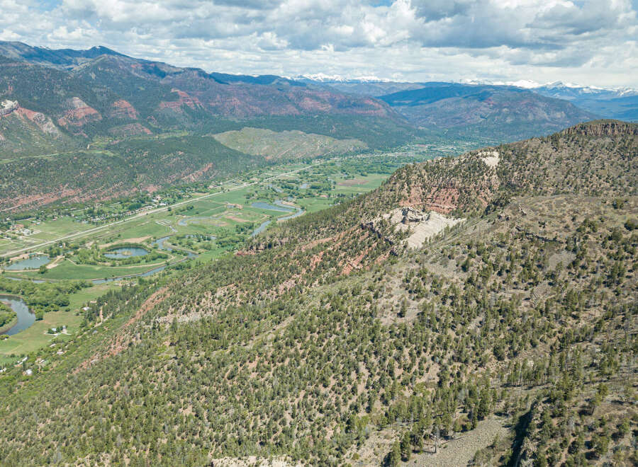 This stunning property boasts breathtaking panoramic views of a picturesque valley, complete with a meandering river and lush greenery.
