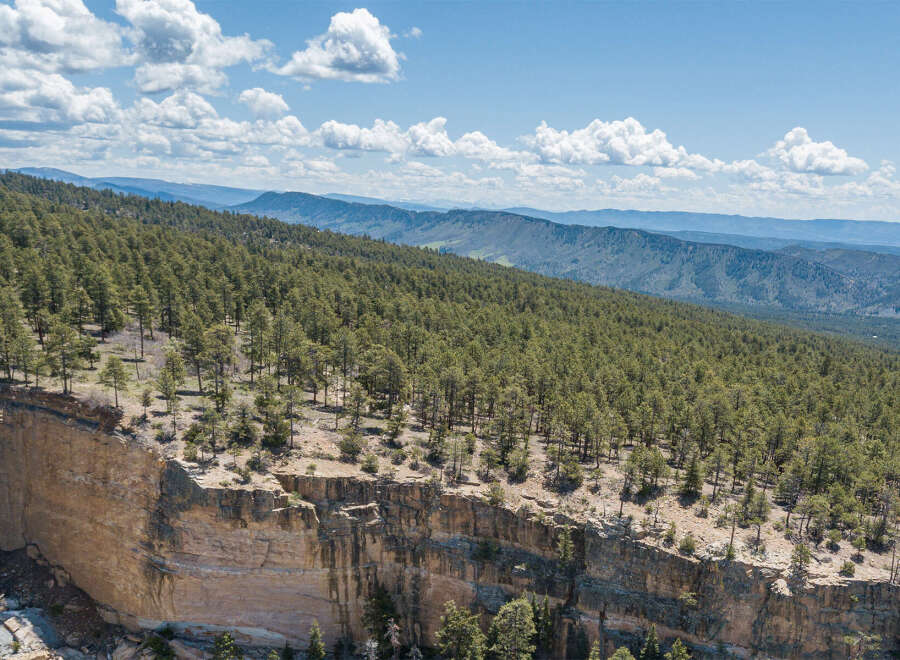 Spectacular cliffside property offering breathtaking panoramic views of rolling hills and mountain ranges.