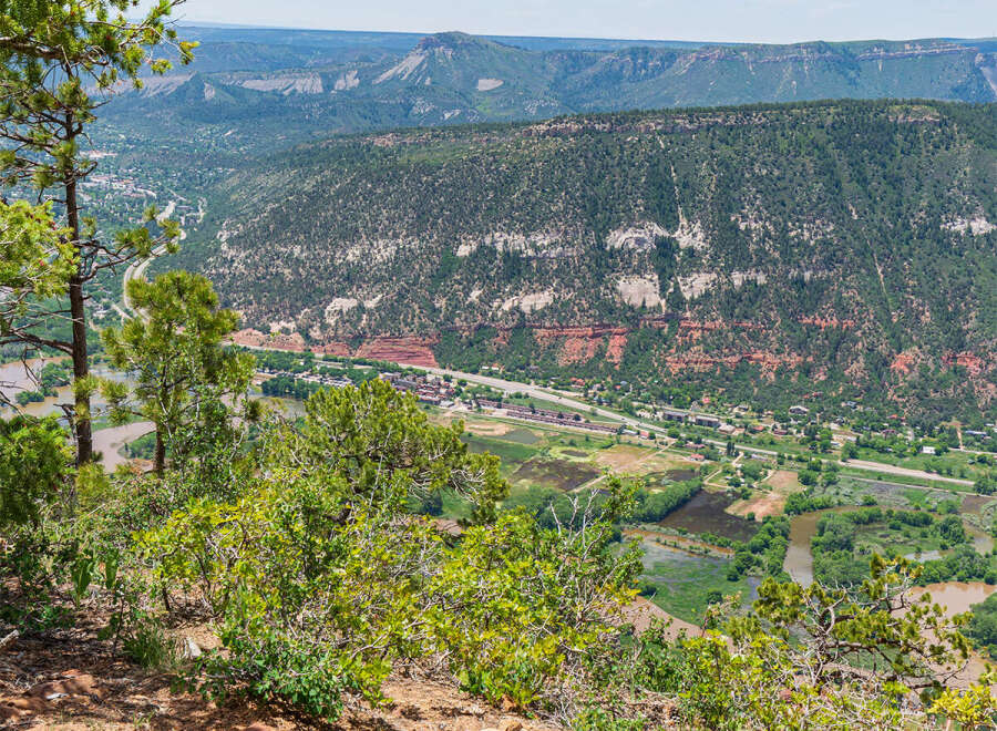 Enjoy breathtaking panoramic views from this rustic stone bench, perched high above a picturesque valley.
