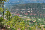 Enjoy breathtaking panoramic views from this rustic stone bench, perched high above a picturesque valley.