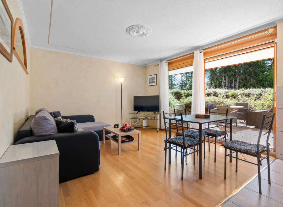 This stunning apartment boasts a spacious living area with large windows offering breathtaking views of the surrounding landscape.
