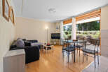 This stunning apartment boasts a spacious living area with large windows offering breathtaking views of the surrounding landscape.
