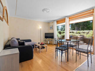 This stunning apartment boasts a spacious living area with large windows offering breathtaking views of the surrounding landscape.