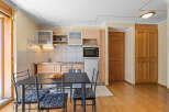 Cozy kitchen and dining area with modern appliances and wooden accents.