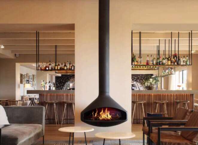 This sophisticated lounge area features a striking suspended fireplace, creating a focal point for relaxation.