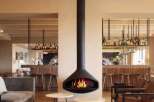 This sophisticated lounge area features a striking suspended fireplace, creating a focal point for relaxation.