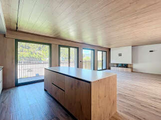 This stunning property boasts an open-plan living area with floor-to-ceiling windows offering breathtaking views.