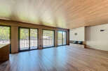 This stunning property boasts a spacious open-plan living area with large windows offering breathtaking views.