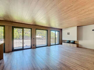This stunning property boasts a spacious open-plan living area with large windows offering breathtaking views.