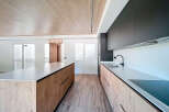 Stunning modern kitchen with sleek dark cabinets and light wood island.
