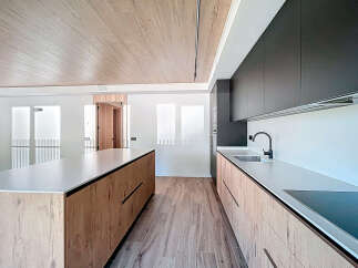 Stunning modern kitchen with sleek dark cabinets and light wood island.