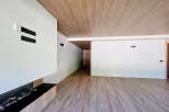 Modern living space featuring a sleek fireplace and wood-look flooring.