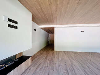 Modern living space featuring a sleek fireplace and wood-look flooring.