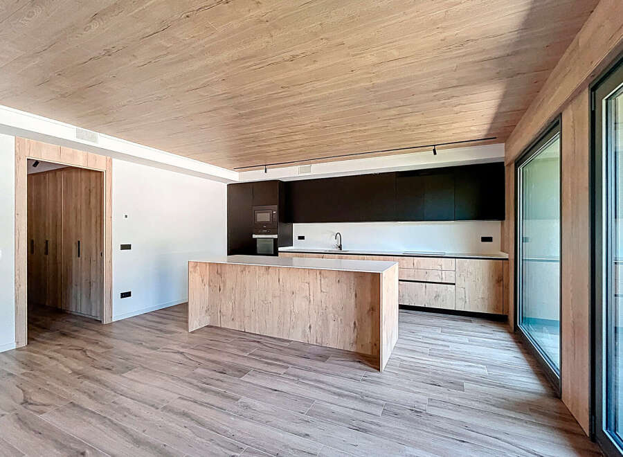 Stunning open-plan kitchen with modern wood and black cabinetry.