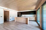 Stunning open-plan kitchen with modern wood and black cabinetry.