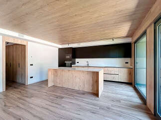 Stunning open-plan kitchen with modern wood and black cabinetry.