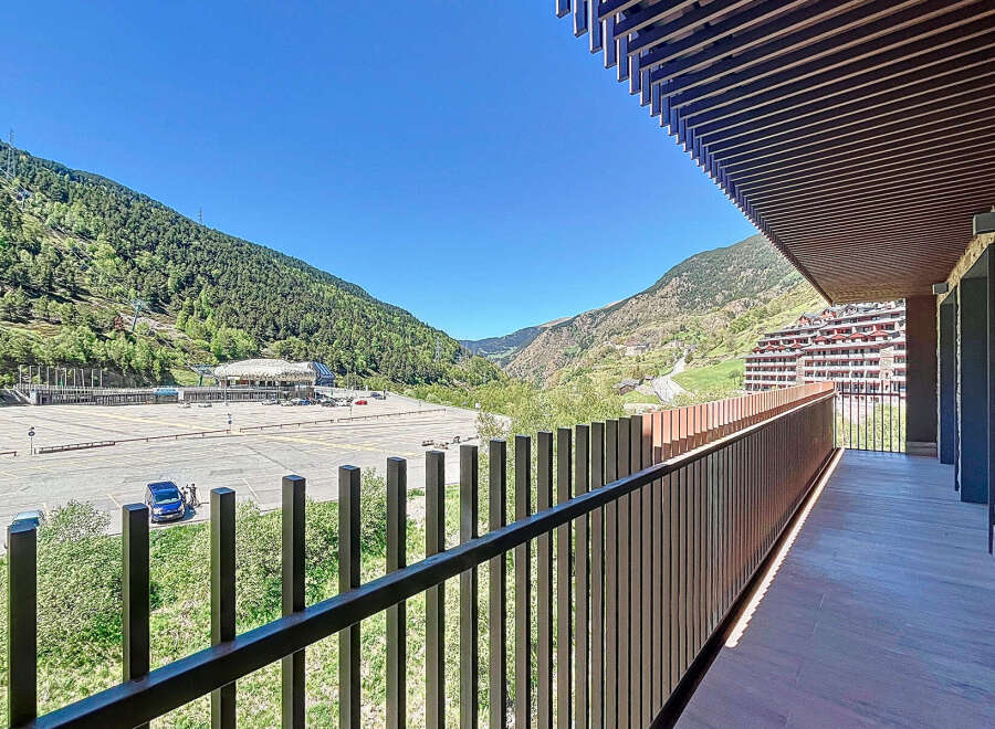 This stunning property boasts a spacious balcony with breathtaking mountain views.