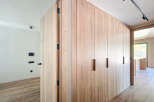 This stunning property boasts a modern design with sleek, light oak wood cabinetry and flooring.