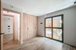 Bright and spacious bedroom with built-in wardrobe and large window offering ample natural light.