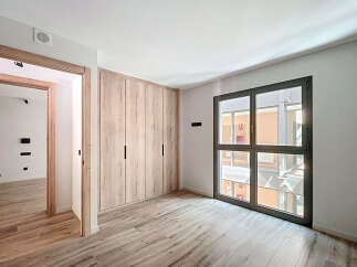 Bright and spacious bedroom with built-in wardrobe and large window offering ample natural light.