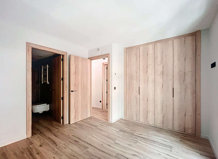 This stunning bedroom boasts a built-in wardrobe with ample storage, perfect for keeping your belongings organized.