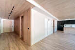 Stunning apartment boasts a spacious open-plan living area with sleek wooden flooring and a modern kitchen.