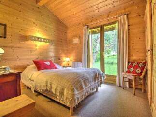 This cozy bedroom features a rustic wooden interior, creating a warm and inviting atmosphere.