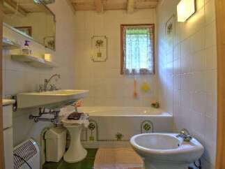 This charming bathroom features a classic design with tiled walls and a cozy atmosphere.