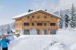 This stunning chalet boasts a prime location in a snow-covered mountain setting.