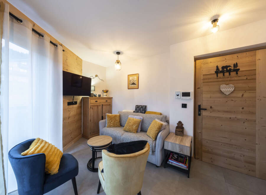 Cozy living room with a comfy sofa and armchairs, perfect for relaxing after a day of adventure.