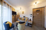 Cozy living room with a comfy sofa and armchairs, perfect for relaxing after a day of adventure.