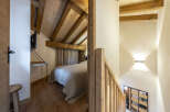 Cozy chalet bedroom with wooden beams and rustic charm.
